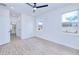 Bright bedroom features wood-look floors, recessed lights, two windows, and an ensuite bathroom at 4290 Oak Terrace Cir, Port Charlotte, FL 33953