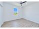 Bright bedroom with a ceiling fan, and a window providing natural light and neighborhood views at 4290 Oak Terrace Cir, Port Charlotte, FL 33953