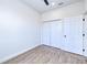 Clean bedroom featuring a ceiling fan, light woodgrain flooring and a spacious closet at 4290 Oak Terrace Cir, Port Charlotte, FL 33953