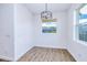 Bright dining area with wood-look floors, large windows, and a modern light fixture at 4290 Oak Terrace Cir, Port Charlotte, FL 33953