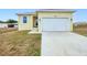 Charming single-Gathering home featuring a large two-car garage and well-maintained front lawn at 4290 Oak Terrace Cir, Port Charlotte, FL 33953