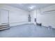 Spacious garage with an epoxy floor, water heater and freshly painted walls at 4290 Oak Terrace Cir, Port Charlotte, FL 33953