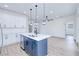 Open concept kitchen with white cabinets, quartz countertops, stainless steel appliances and an island with a sink at 4290 Oak Terrace Cir, Port Charlotte, FL 33953