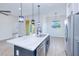 Open kitchen with modern lighting, an island with stainless steel sink, and stainless steel appliances at 4290 Oak Terrace Cir, Port Charlotte, FL 33953