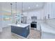 Modern kitchen featuring stainless steel appliances, an island with a sink, and bright white cabinets at 4290 Oak Terrace Cir, Port Charlotte, FL 33953