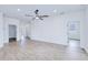 Spacious and bright living room with recessed lighting, wood-look floors, and multiple doorways at 4290 Oak Terrace Cir, Port Charlotte, FL 33953