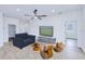 Cozy living room with neutral tones, a ceiling fan, and natural light, creating a relaxing atmosphere at 4290 Oak Terrace Cir, Port Charlotte, FL 33953