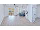 Open-concept floor plan with light woodgrain floors, a large sliding glass door and bright white walls at 4290 Oak Terrace Cir, Port Charlotte, FL 33953