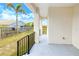 A lovely outdoor patio with black railings and a view of the fenced yard at 4290 Oak Terrace Cir, Port Charlotte, FL 33953