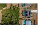 Aerial view of home with backyard pool, solar panels, landscaping, and adjacent wooded lot at 4339 Boggs St, Port Charlotte, FL 33948