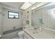 Bright bathroom with shower and tub combination, with decor and window at 4339 Boggs St, Port Charlotte, FL 33948