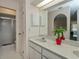 Bathroom featuring a single sink vanity, a decorative mirror, and a walk-in shower at 4339 Boggs St, Port Charlotte, FL 33948