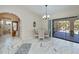 Dining room with a chandelier and sliding glass doors to screened patio at 4339 Boggs St, Port Charlotte, FL 33948