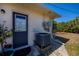Home exterior featuring the air conditioning unit, electric meter, and a back door leading to the backyard at 4339 Boggs St, Port Charlotte, FL 33948