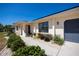 Well-kept home featuring fresh landscaping, an arched entrance and a 2-car garage at 4339 Boggs St, Port Charlotte, FL 33948