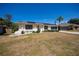 Cozy home with a well-maintained lawn, clean driveway and beautiful bushes at 4339 Boggs St, Port Charlotte, FL 33948