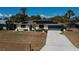 Attractive home with a manicured lawn, solar panels, and a charming front garden at 4339 Boggs St, Port Charlotte, FL 33948