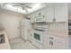 Bright kitchen area with white cabinetry, white appliances, and marble tile floor at 4339 Boggs St, Port Charlotte, FL 33948