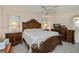 Traditional main bedroom with wooden furniture, lamps, and a ceiling fan at 4339 Boggs St, Port Charlotte, FL 33948