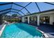Beautiful screened-in pool with an inviting outdoor dining area and access to the home's interior at 4339 Boggs St, Port Charlotte, FL 33948