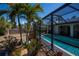 Screened-in pool area surrounded by lush landscaping, mature trees, and a private backyard at 4339 Boggs St, Port Charlotte, FL 33948