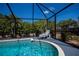 Relaxing screened-in pool with lounge chairs and beautifully landscaped surroundings at 4339 Boggs St, Port Charlotte, FL 33948
