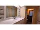 Bathroom featuring a vanity with a white countertop, a large mirror, and closet space at 570 Mimosa Nw Ave, Port Charlotte, FL 33952