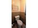 Cozy bathroom displaying toilet with a matching towel rack against tiled walls at 570 Mimosa Nw Ave, Port Charlotte, FL 33952