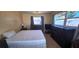 Bedroom with two large windows, ceiling fan, and tile flooring, including dressers at 570 Mimosa Nw Ave, Port Charlotte, FL 33952