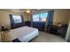 Bedroom with two large windows, ceiling fan, and tile flooring, including sewing machine at 570 Mimosa Nw Ave, Port Charlotte, FL 33952
