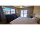 Bedroom with sliding glass door providing pool access and a relaxing backyard view at 570 Mimosa Nw Ave, Port Charlotte, FL 33952