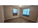 Cozy bedroom with wood-look flooring and ample natural light at 570 Mimosa Nw Ave, Port Charlotte, FL 33952