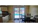 Eat-in kitchen with sliding glass doors leading to the pool area, and stone topped table at 570 Mimosa Nw Ave, Port Charlotte, FL 33952