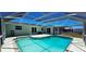 Refreshing screened-in pool featuring ample patio space for entertaining and relaxation at 570 Mimosa Nw Ave, Port Charlotte, FL 33952