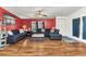 Cozy living room with wood floors, comfortable seating, and bright, natural light at 6144 Redwing Ave, Englewood, FL 34224