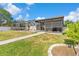 A spacious backyard featuring a screened-in pool area and green lawn, perfect for outdoor activities and relaxation at 6604 Ranger Dr, Tampa, FL 33615
