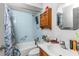 A functional bathroom with a shower-tub combination, wooden cabinet, and essential toiletries at 6604 Ranger Dr, Tampa, FL 33615