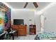 A cozy bedroom featuring a ceiling fan, dresser, and colorful decor, providing a comfortable personal space at 6604 Ranger Dr, Tampa, FL 33615