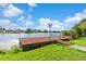 Waterfront property with personal dock and walkway on a sunny day at 6604 Ranger Dr, Tampa, FL 33615