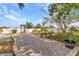 Landscaped backyard with brick paver patio and a tranquil water feature at 6753 Thorman Rd, Port Charlotte, FL 33981