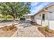 Charming backyard features a brick patio, lush foliage, and a white-painted home exterior at 6753 Thorman Rd, Port Charlotte, FL 33981