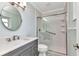 Bathroom with new glass door walk-in shower, white subway tile and grey vanity at 6753 Thorman Rd, Port Charlotte, FL 33981