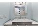 Bathroom vanity with marble countertop, stainless steel faucet and large mirror at 6753 Thorman Rd, Port Charlotte, FL 33981
