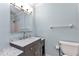 Bathroom with grey vanity, marble countertop, stainless steel faucet, and large mirror at 6753 Thorman Rd, Port Charlotte, FL 33981