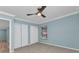 Bedroom featuring a modern ceiling fan, light blue walls, and neutral flooring at 6753 Thorman Rd, Port Charlotte, FL 33981