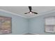 Bedroom with a modern ceiling fan, light blue walls, and neutral flooring at 6753 Thorman Rd, Port Charlotte, FL 33981
