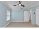 Bedroom with a modern ceiling fan, light blue walls, and neutral flooring at 6753 Thorman Rd, Port Charlotte, FL 33981