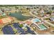 Aerial view of community amenities including a pool, tennis courts, and clubhouse at 6753 Thorman Rd, Port Charlotte, FL 33981