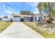 Charming single-story home with a well-manicured lawn, attached garage, and inviting front entrance at 6753 Thorman Rd, Port Charlotte, FL 33981