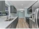 Updated kitchen features gray cabinets, stainless steel appliances, tile backsplash and white countertops at 6753 Thorman Rd, Port Charlotte, FL 33981